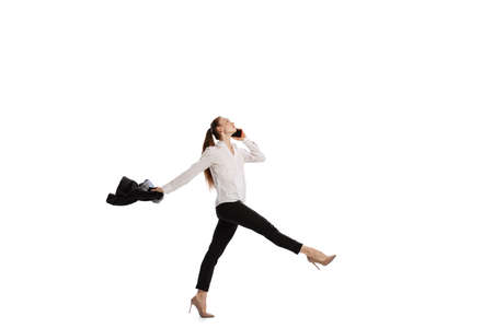 Happy business woman dancing and smiling isolated over white background. Emotions, finance, aspiration, business, job concept.の写真素材
