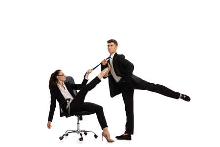 Disputed issues. Two stylish office workers in business suits in action isolated on white...