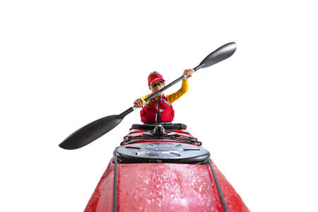 Beginner kayaker in red canoe, kayak with a life vest and a paddle isolated on white background. Concept of sport, nature, travel, active lifestyleの写真素材