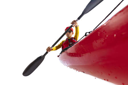 Beginner kayaker in red canoe, kayak with a life vest and a paddle isolated on white background. Concept of sport, nature, travel, active lifestyleの写真素材