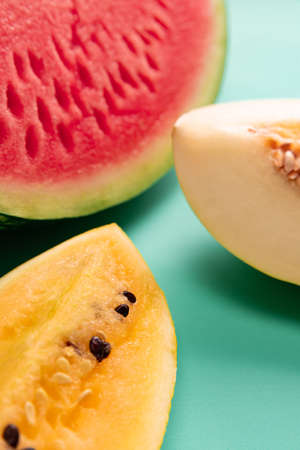 Healthy and tasty. Top view of ripe fresh watermelon and melon slices over colorful background....