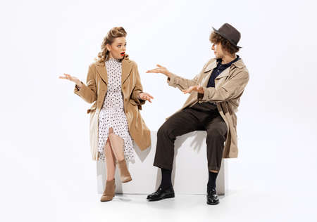 Young man and surprised beautiful woman in 70s, 80s fashion style attires isolated on white background. Concept of culture, art, music, style, adの写真素材