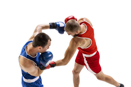 Fight. Professional male boxer in sports uniform and gloves training isolated on white background. Concept of sport, competition, training, energyの写真素材