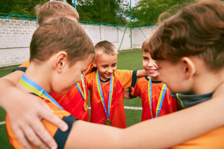 Support, motivation. Children, junior soccer team standing together in circle. Concept of sport, competition, studying and achievementsの写真素材