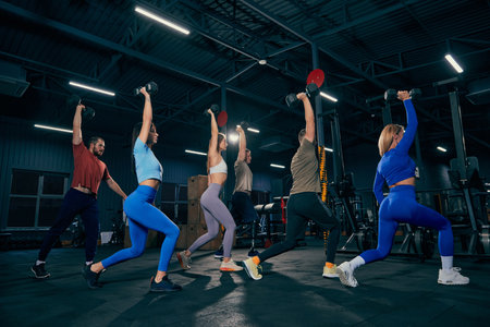 Group of young people doing sports, workout at sport gym, indoors. Sport, active lifestyle, health,...