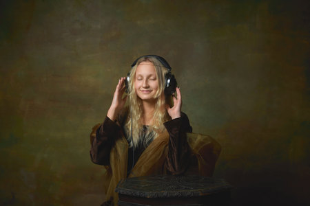 Soul music. Vintage style portrait of young charming girl in image of Mona Lisa, La Gioconda isolated on dark green background. Art, beauty, style, imitationの写真素材