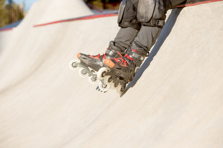 Mans legs in rollerblades. Leisure activities outdoors in autumn sunny day. Concept of active...
