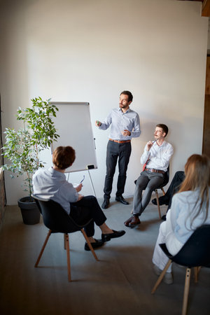 Young people talking, working, discussing problems and ideas with colleagues, co-workers at office...