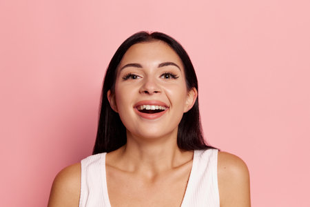 Surprise. Winning success happy woman celebrating being a winner. Image of caucasian female model on pink studio background. Victory, delight concept. Human facial emotions concept.の写真素材