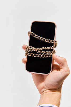 Conceptual image of phone with chain symbolizing blockchain system. Storage and distribution of...