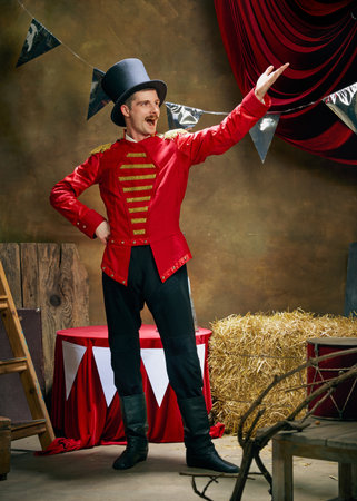 Vintage portrait of male retro circus entertainer expresses rejoice and announces start of show over...