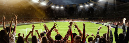 Back view of group of people, football soccer fans cheering at crowded football stadium at evening time. Concept of sport, cup, world, team, event, competitionの写真素材