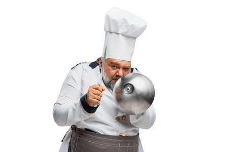 Portrait of bearded man, restaurant chef in uniform posing with bowl and knife isolated on white background. Funny cookの写真素材