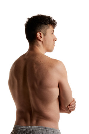 Side view photo of mature man posing shirtless in pants over white studio background. Relief, strong back. Mens health and beautyの写真素材