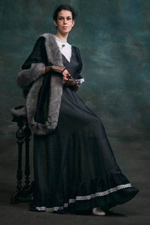 Femininity. Beautiful woman in image of Anna Karenina over vintage dark green background. Concept of...