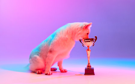 Champion. Studio shot of White Swiss Shepherd Dog posing with trophy isolated over gradient pink...