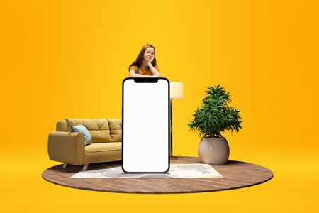 Young calm girl standing behind giant 3D model of mobile phone with empty screen for text, ad....