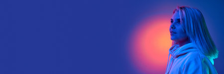 Innovations, new vision. Young woman over gradient purple studio background in blue neon light....