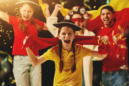 Group of emotional young people and teens cheering up german football team during championship. Successful winning gameの写真素材