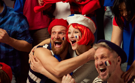 Happiness. Football, soccer fans emotionally cheering up favourite france team. People wearing...