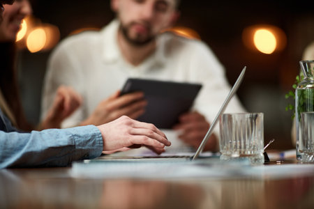 Close-up image of male hands typing on laptop. Business people, employees meeting at office,...