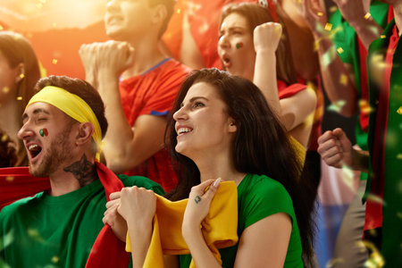 Portugal football, soccer fans cheering their team at stadium. Excited fans cheering a goal, supporting favourite playersの写真素材