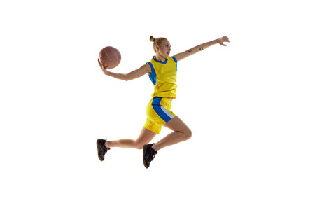 Young girl in motion, throwing ball in jump, playing, training basketball against white studio background. Concept of professional sportの写真素材