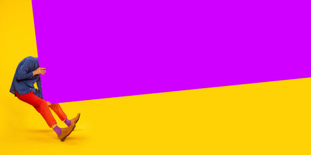 Ambitions and motivation. Man in colorful, stylish clothes over yellow background with purple elementの写真素材