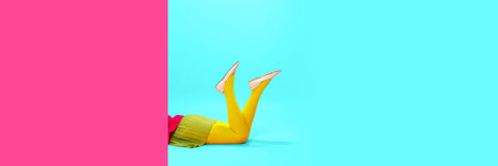 Female legs in yellow tights over vivid pink and blue background. Shopping, season sales. Bannerの写真素材