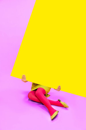 Female legs in colorful tights over yellow and pink background. Empty space for text. Pop art photography.の写真素材