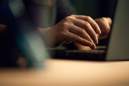 Close-up image of female hands typing on keyboard. Business woman working on laptop, making projectsの写真素材