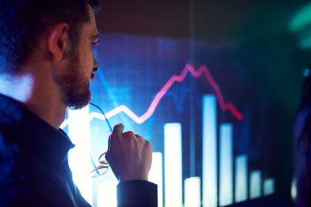 Close-up of male face attentively looking on screen showing presentation, graphs and analytics. CEO businessman in meetingの写真素材