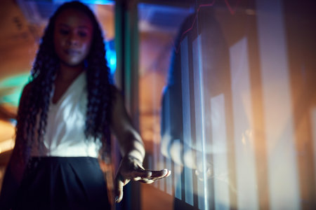 Young african woman leading business conference, showing digital presentation, analytics and...