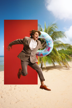 Excited businessman in formalwear holding swimming circle and jumping into beach with palms. Summertime rest. Creative collage.の写真素材