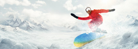 Young man, lover of active vacation and lifestyle, riding on snowboard around snowy mountains backgroundの写真素材