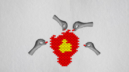 Contemporary art collage. Human hands connecting bricks and building light bulb symbolizing well-coordinated teamwork and successful ideasの写真素材