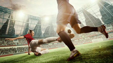 Dynamic image of female football players in motion during match, game. Woman hitting ball and falling down. 3d arena, blurred audienceの写真素材