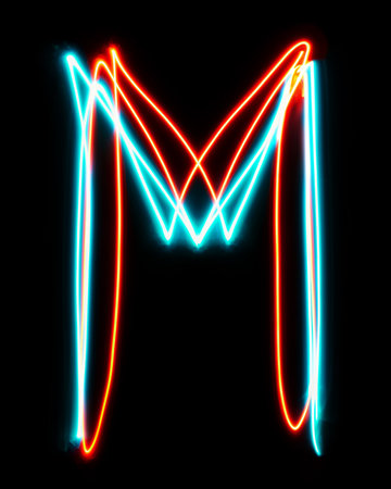 Letter M of the alphabet made from neon sign. The blue red light image, long exposure with colored fairy lights, against a black backgroundの写真素材