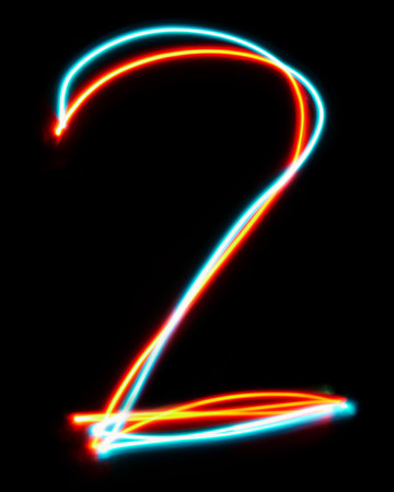 Number 2 of the alphabet made from neon sign. The blue red light image, long exposure with colored fairy lights, against a black background.の写真素材