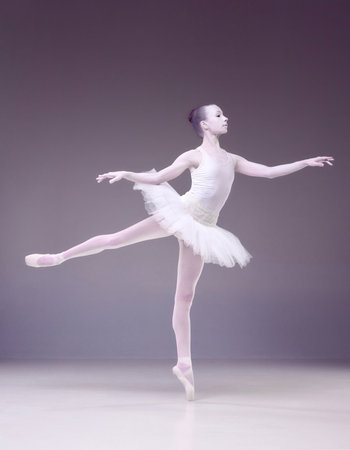 Full-length of tender young woman, professional ballerina posing over purple studio background. Porcelain statue styleの写真素材