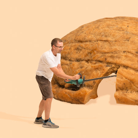 Man cutting banana brad, pie, dessert with saw over beige background. Contemporary art collage.の写真素材