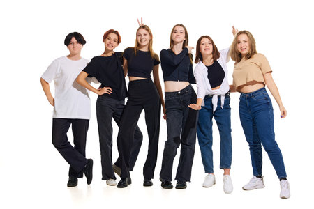 Group of young beautiful people, teenagers dressed trendy casual outfit against white studio background. Concept of fashion.の写真素材