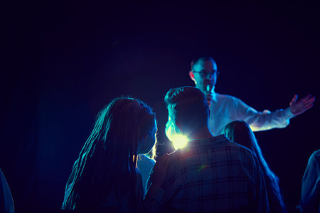 Young people, man and woman attending business seminar, conference, meeting, listening to tutor and...