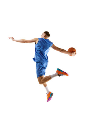 Slum dunk. Full-length image of young guy, basketball player in motion, jumping with ball isolated over white background. Sport conceptの写真素材