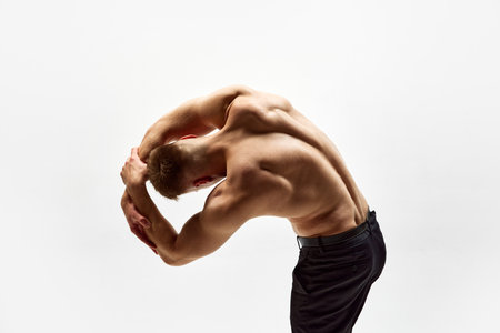 Muscular young man with relief fit shirtless body standing with round back, stanching isolated over...