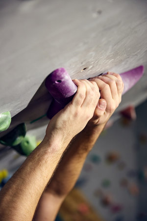 Close-up of hands in special powder on artificial rock. Bouldering, wall climbing activityの写真素材
