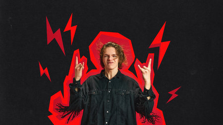 Young man in stylish jacket with overlined body, showing rock and roll hand symbol over black...