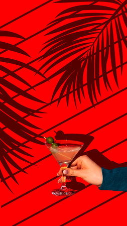 Contemporary art collage. Neon Martini. Female Hand holds sweet and sour cocktail garnished with green olives against vivid background with plants shadows.の写真素材