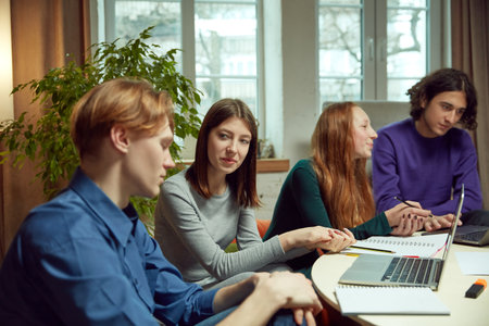 Young boys and girls, student meeting in university library for studying and doing projects...