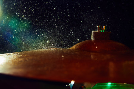 Close-up image of drum element on black background with light and waterdrops. Dynamics, energy.の写真素材